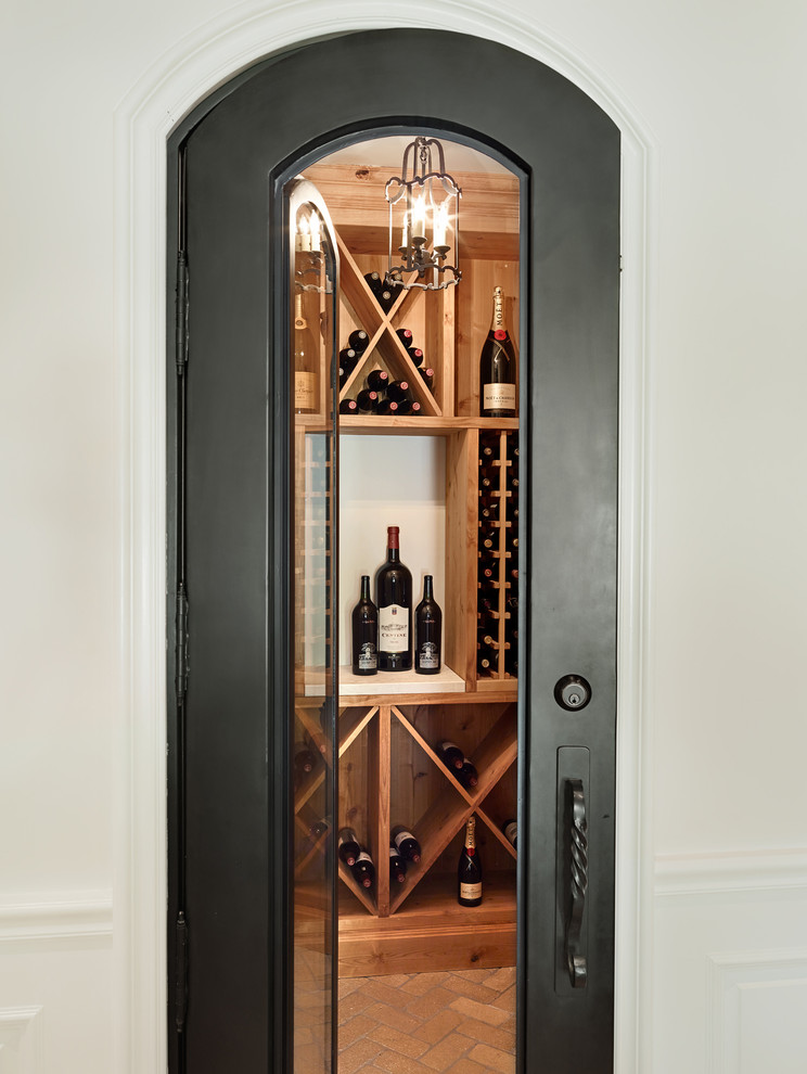 Inspiration for a mediterranean wine cellar in Phoenix with brick floors and diamond bins.