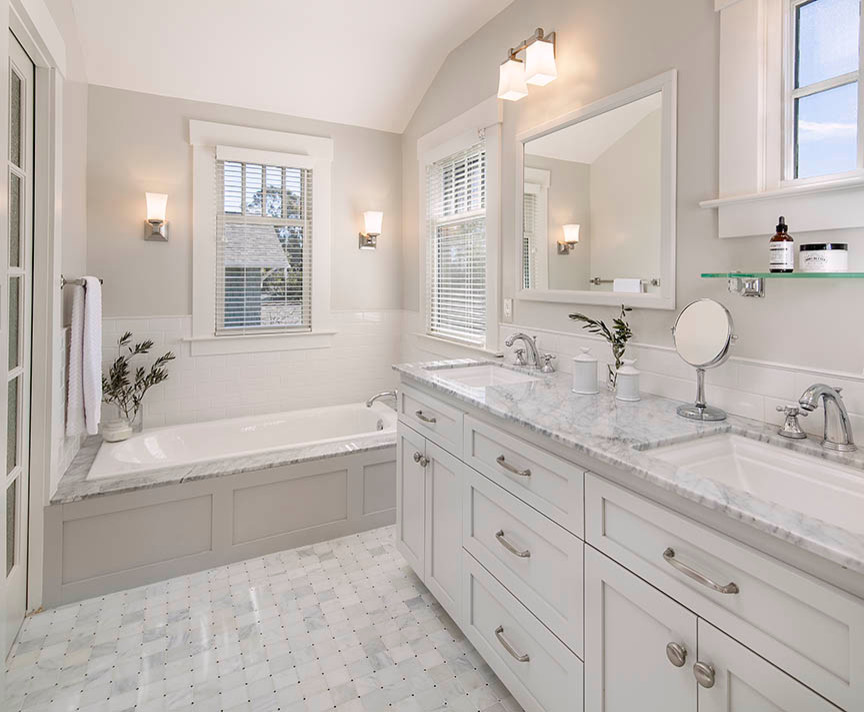 Design ideas for a small transitional master bathroom in Santa Barbara with recessed-panel cabinets, white cabinets, a drop-in tub, an alcove shower, white tile, ceramic tile, white walls, marble floors, an undermount sink and granite benchtops.