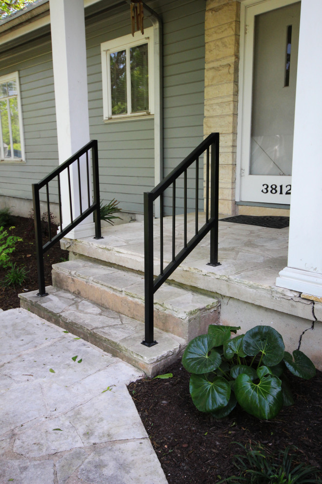 Medium sized classic front metal railing veranda in Austin with with columns, concrete slabs and a roof extension.