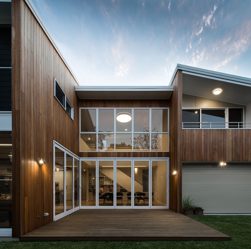 Photo of a contemporary two-storey exterior in Sydney with wood siding.
