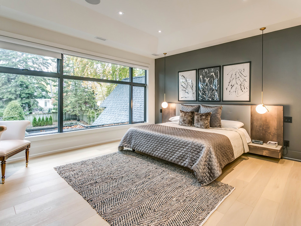 Design ideas for a large contemporary master bedroom in Toronto with light hardwood floors, beige floor and grey walls.