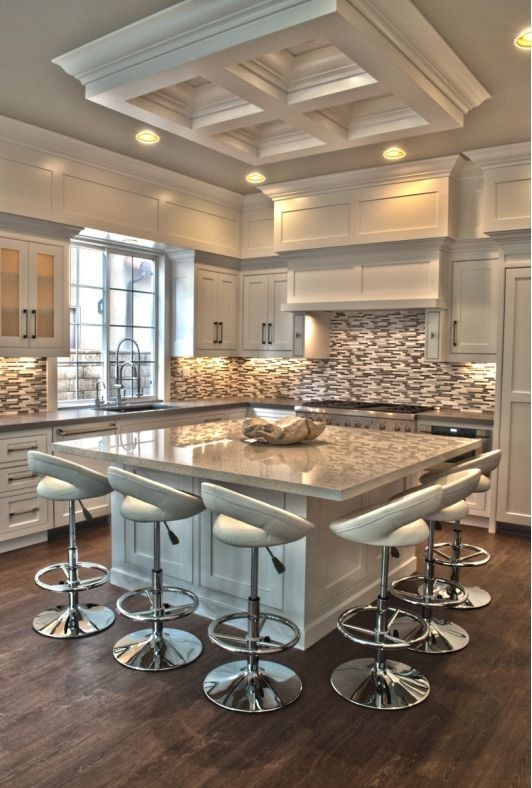 Mid-sized transitional l-shaped medium tone wood floor kitchen photo in Chicago with shaker cabinets, stainless steel appliances, an undermount sink, white cabinets, multicolored backsplash, mosaic tile backsplash and an island