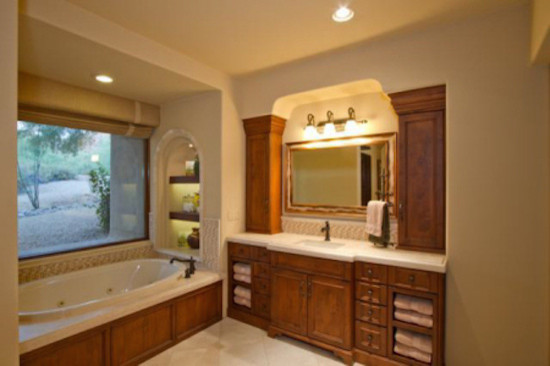 Example of a transitional brown tile bathroom design in Phoenix with a vessel sink, raised-panel cabinets, medium tone wood cabinets and white walls