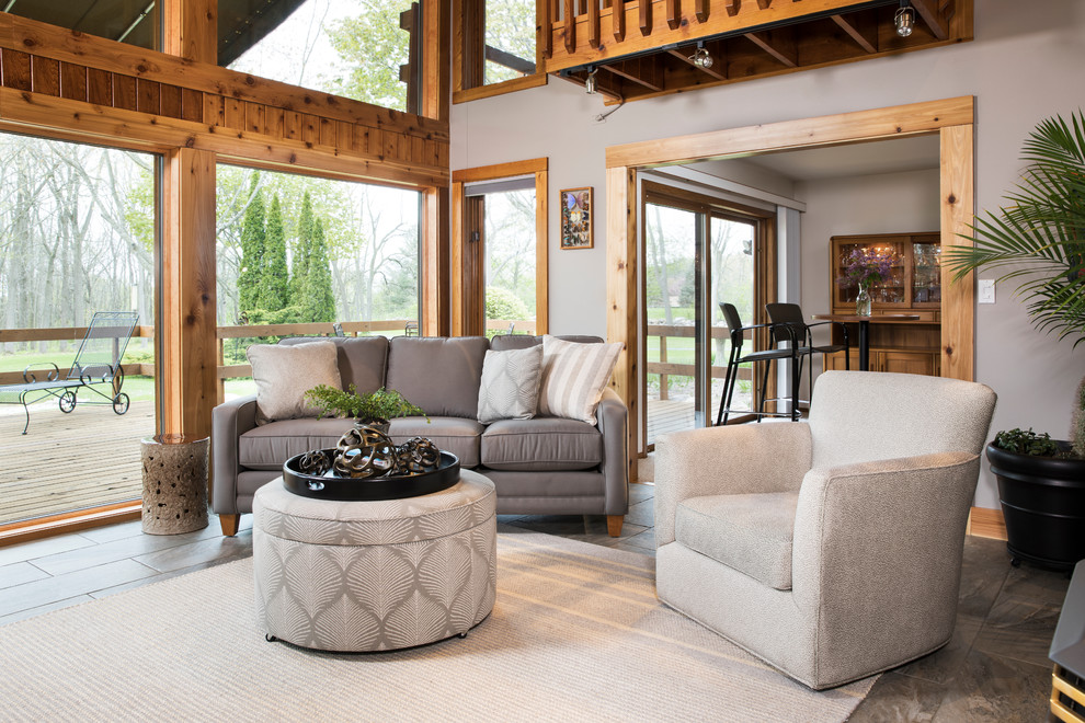 This is an example of a mid-sized country formal open concept living room in Milwaukee with grey walls, slate floors, no fireplace, no tv and blue floor.