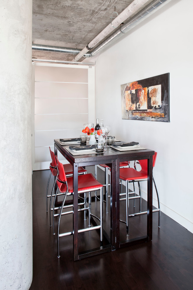 Inspiration for a mid-sized industrial open plan dining in Toronto with white walls and dark hardwood floors.
