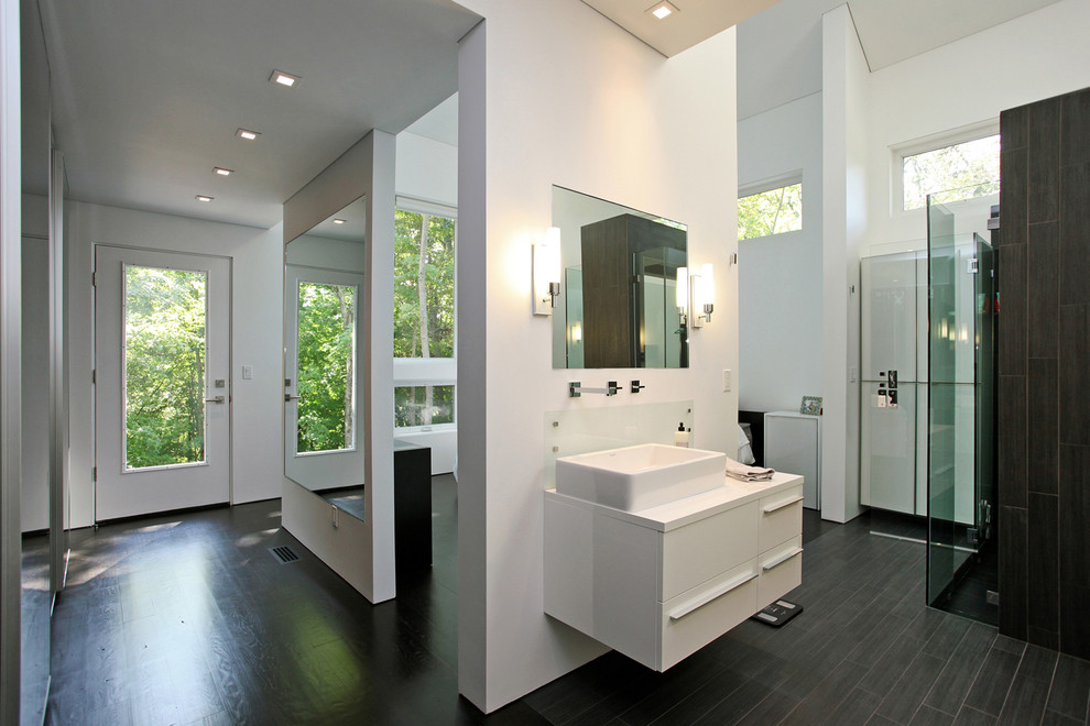 Design ideas for a contemporary bathroom in New York with wood-look tile, a vessel sink, flat-panel cabinets, laminate benchtops, white cabinets, black tile, white walls, dark hardwood floors, an open shower and a one-piece toilet.