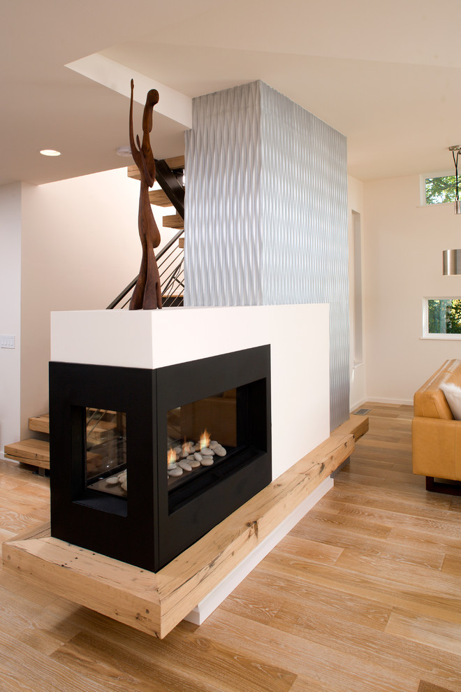 Inspiration for a mid-sized contemporary formal open concept living room in Minneapolis with white walls, light hardwood floors, a two-sided fireplace, a metal fireplace surround, no tv and brown floor.