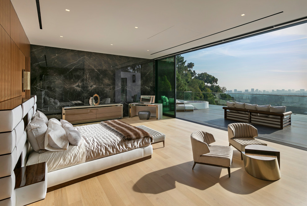 Expansive contemporary master bedroom in Los Angeles with brown walls and beige floor.