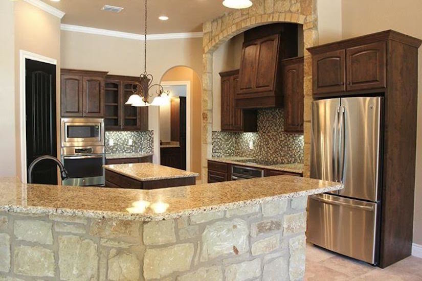 Photo of a mid-sized country l-shaped eat-in kitchen in Austin with an undermount sink, raised-panel cabinets, dark wood cabinets, granite benchtops, beige splashback, ceramic splashback, stainless steel appliances, ceramic floors and with island.