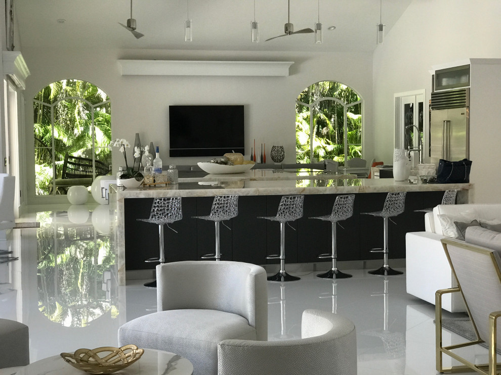 Design ideas for a large modern open plan kitchen in Miami with a farmhouse sink, flat-panel cabinets, white cabinets, onyx benchtops, multi-coloured splashback, glass sheet splashback, stainless steel appliances, ceramic floors, multiple islands, white floor and multi-coloured benchtop.
