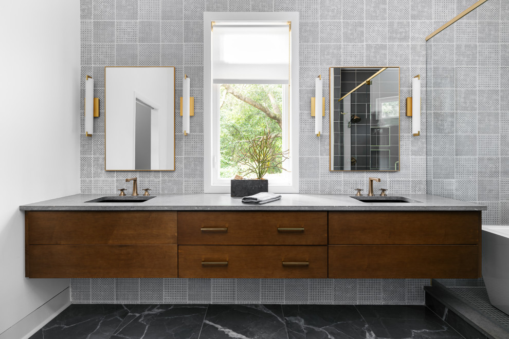 Large trendy master gray tile and porcelain tile gray floor and double-sink freestanding bathtub photo in Atlanta with flat-panel cabinets, medium tone wood cabinets, quartz countertops, gray countertops and a floating vanity