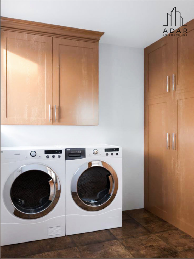 Photo of a large transitional u-shaped laundry room in Los Angeles with recessed-panel cabinets, granite benchtops, mosaic tile splashback and white benchtop.