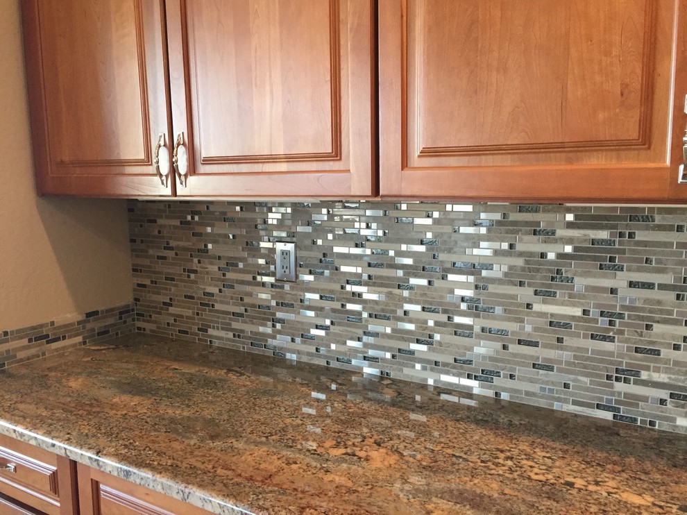 Elegant kitchen photo in Phoenix with raised-panel cabinets, medium tone wood cabinets and granite countertops