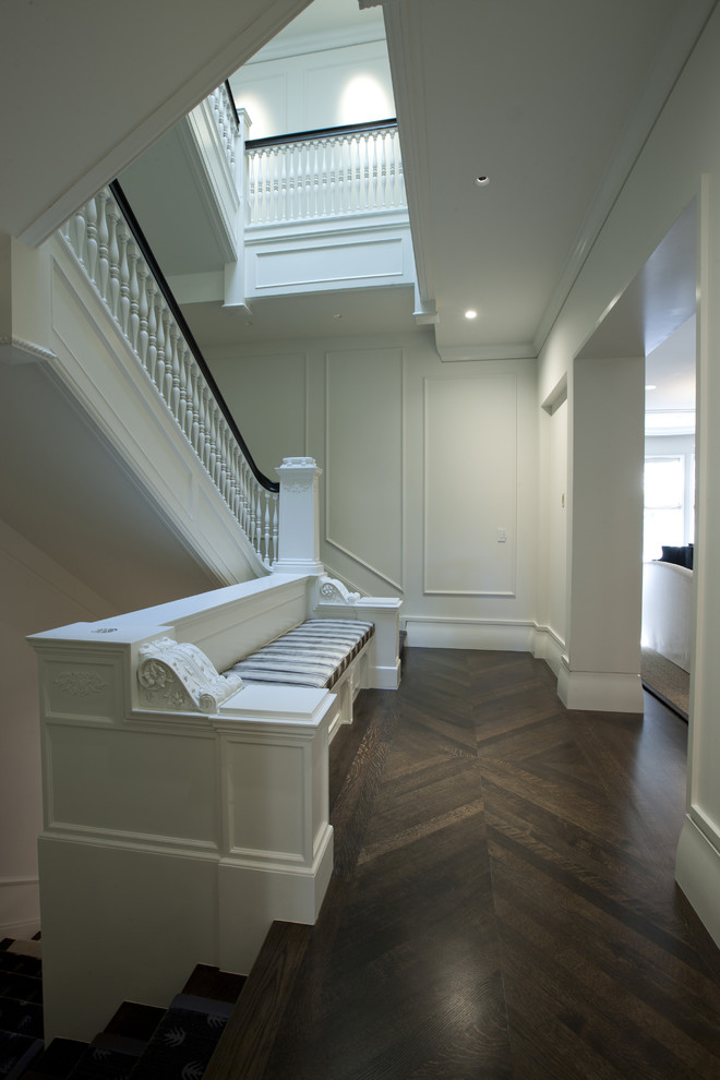 Inspiration for a contemporary hallway in Chicago with white walls and dark hardwood floors.