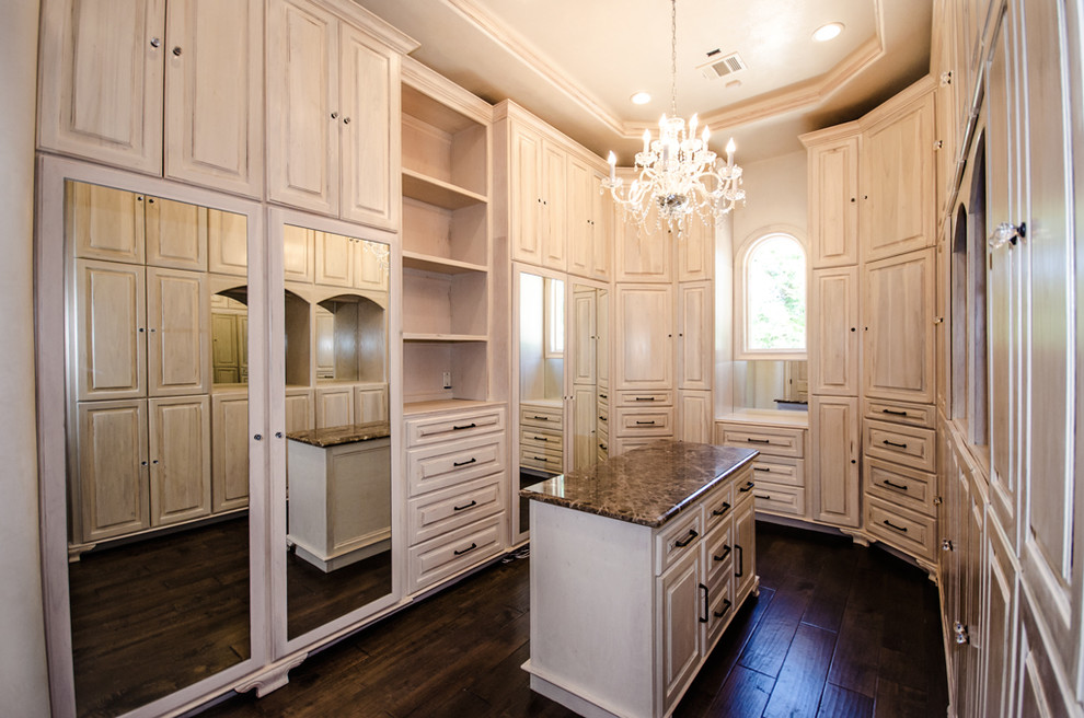 Inspiration for an expansive traditional women's storage and wardrobe in Houston with flat-panel cabinets, light wood cabinets and dark hardwood floors.