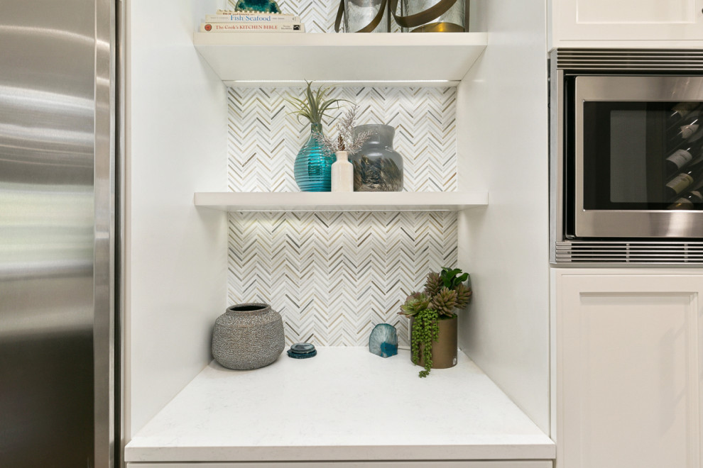 Inspiration for a huge transitional u-shaped travertine floor and beige floor open concept kitchen remodel in Orange County with a single-bowl sink, shaker cabinets, white cabinets, quartz countertops, multicolored backsplash, stone tile backsplash, stainless steel appliances, an island and white countertops