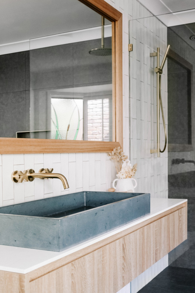 Photo of an industrial master bathroom in Gold Coast - Tweed with blue cabinets, white tile, subway tile, white walls, granite benchtops, white benchtops, a single vanity and a floating vanity.
