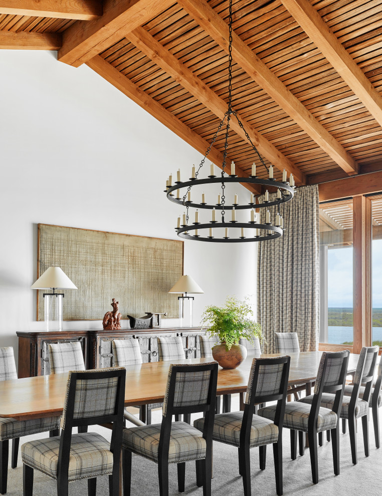 Inspiration for a large country separate dining room in Austin with white walls, light hardwood floors, brown floor and timber.