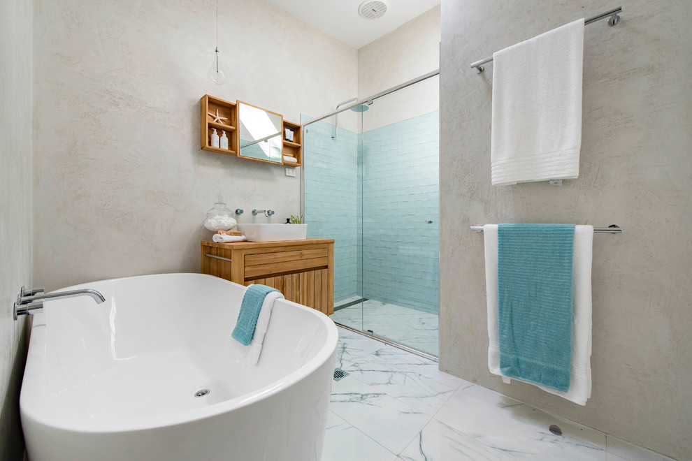 Design ideas for a mid-sized contemporary master bathroom in Canberra - Queanbeyan with furniture-like cabinets, medium wood cabinets, a freestanding tub, an alcove shower, green tile, ceramic tile, beige walls, ceramic floors, a vessel sink and wood benchtops.