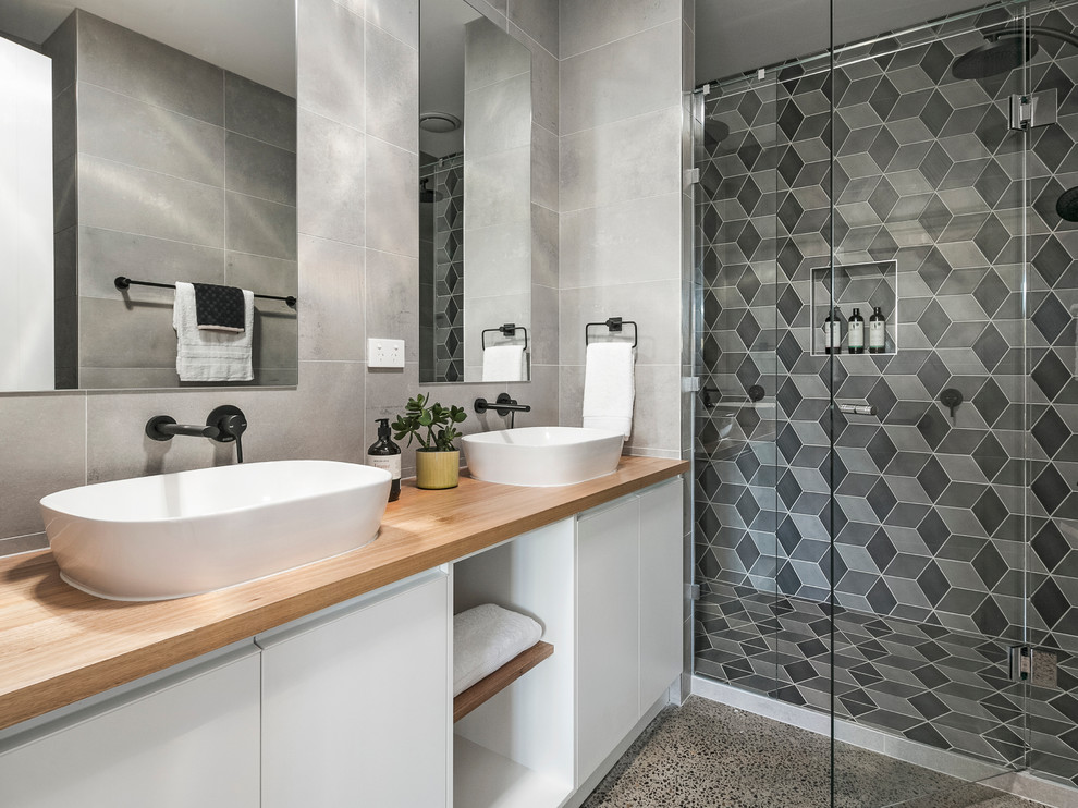 Inspiration for a contemporary 3/4 bathroom in Melbourne with flat-panel cabinets, white cabinets, an alcove shower, gray tile, a vessel sink, wood benchtops, a hinged shower door and brown benchtops.