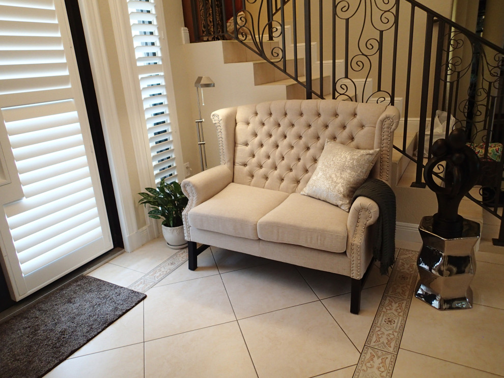 Foyer - transitional porcelain tile and beige floor foyer idea in Miami with beige walls