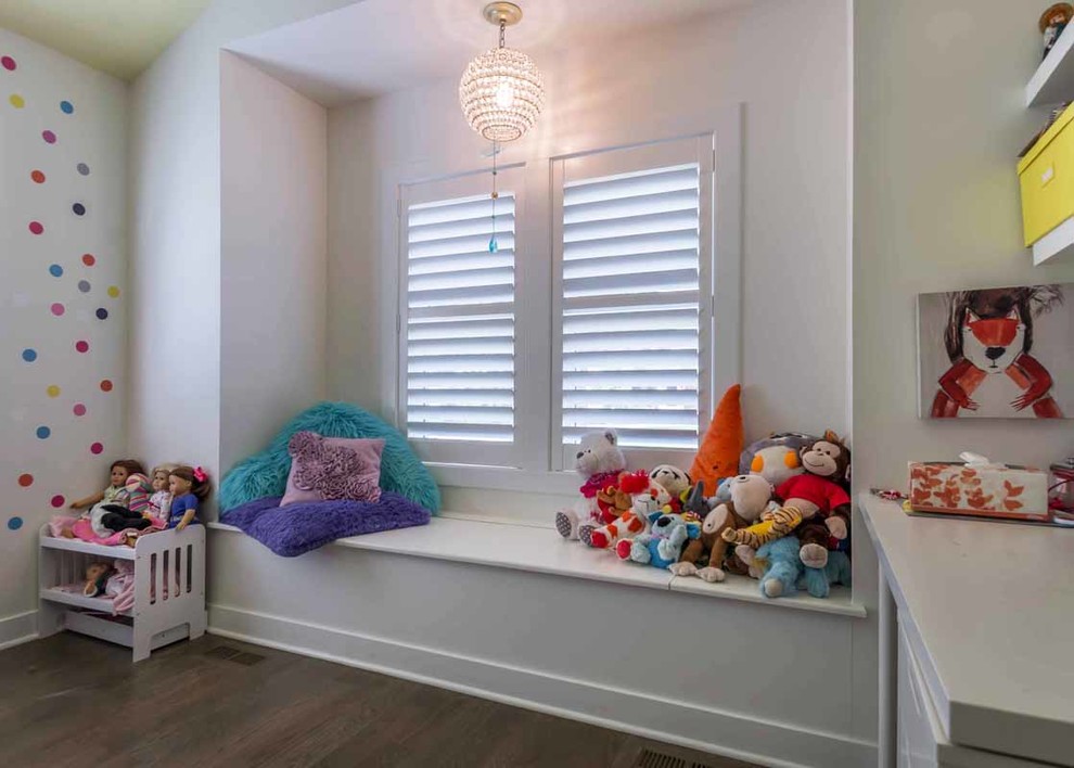 This is an example of a large contemporary kids' bedroom for kids 4-10 years old and girls in Chicago with white walls, brown floor, dark hardwood floors, vaulted and wallpaper.