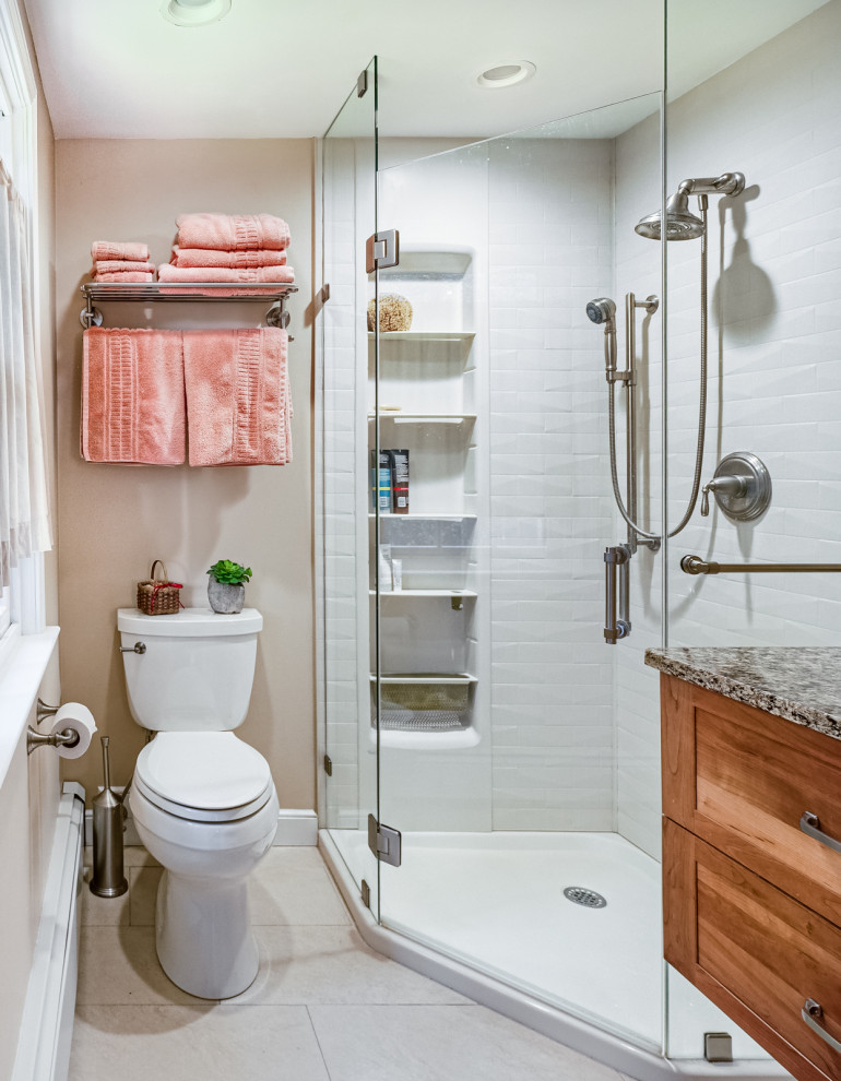 Design ideas for a small eclectic master bathroom in Boston with shaker cabinets, medium wood cabinets, a corner shower, white walls, ceramic floors, an undermount sink, granite benchtops, a hinged shower door, multi-coloured benchtops, a niche, a single vanity and a floating vanity.