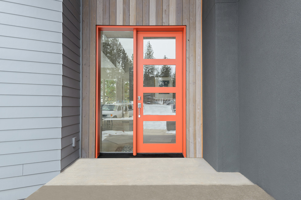 Inspiration for a contemporary front door in Other with a single front door and an orange front door.