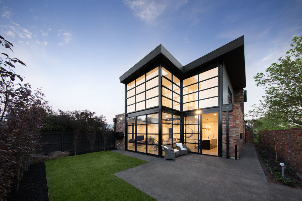 This is an example of a mid-sized contemporary two-storey brick brown exterior in Melbourne.