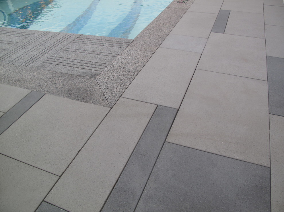 This is an example of a mid-sized beach style backyard patio in Providence with a water feature and concrete pavers.
