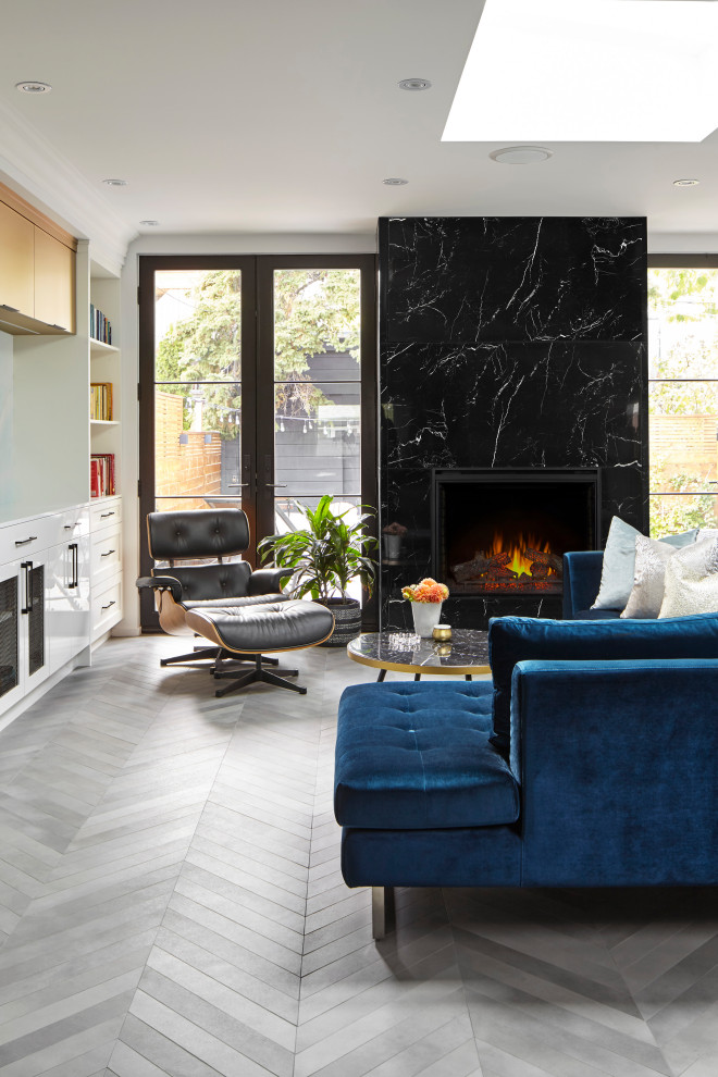 Inspiration for a mid-sized contemporary open concept family room in Toronto with white walls, porcelain floors, a standard fireplace, a tile fireplace surround and grey floor.