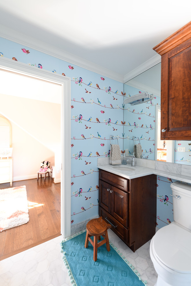 Example of a large transitional 3/4 white tile and subway tile marble floor and white floor alcove bathtub design with raised-panel cabinets, dark wood cabinets, a two-piece toilet, gray walls, an undermount sink, quartzite countertops and white countertops