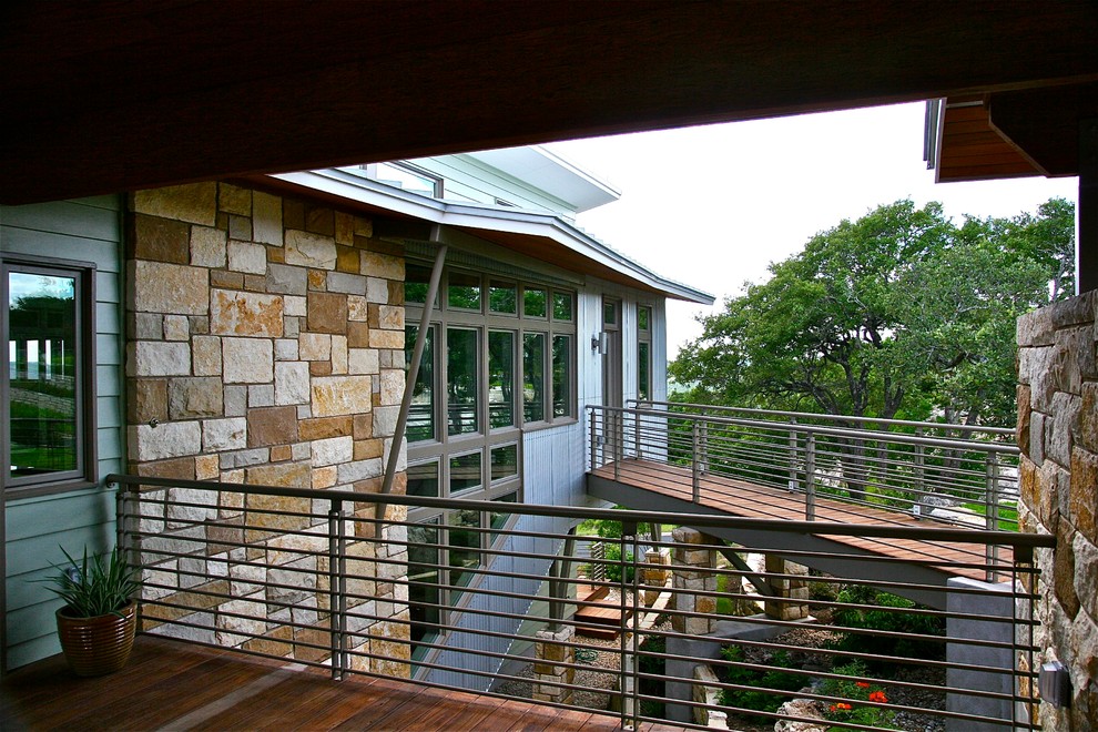 Mid-sized contemporary two-storey exterior in Austin with stone veneer.
