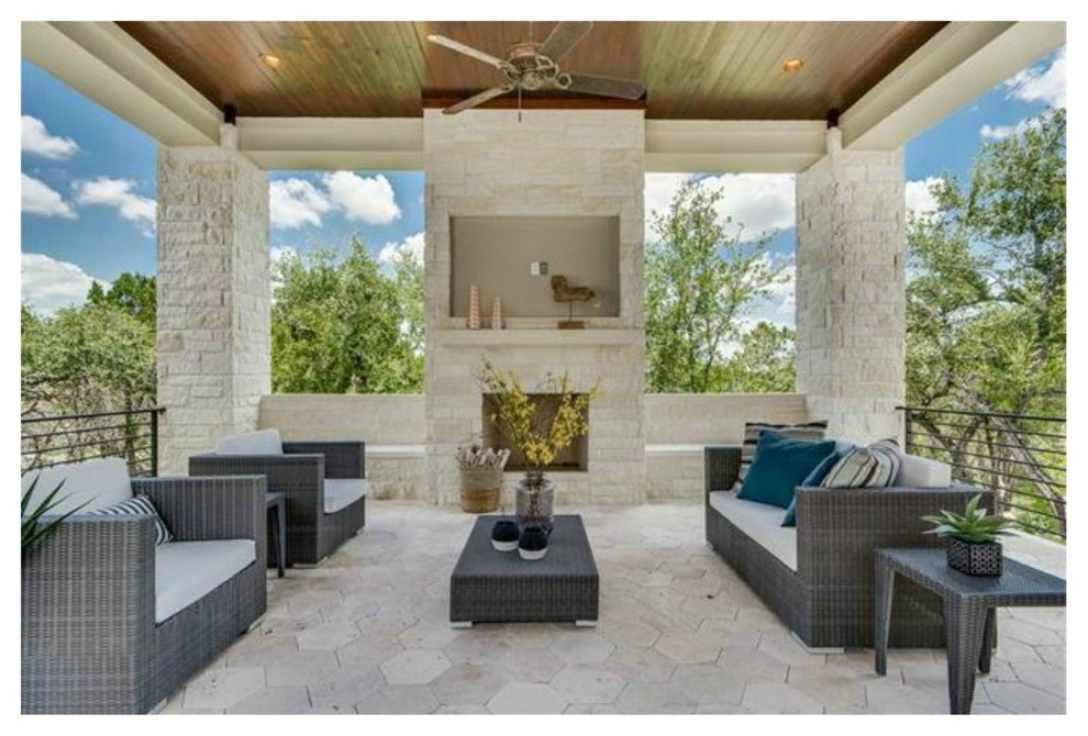 Design ideas for a large contemporary courtyard custom-shaped natural pool in Austin with a hot tub and natural stone pavers.