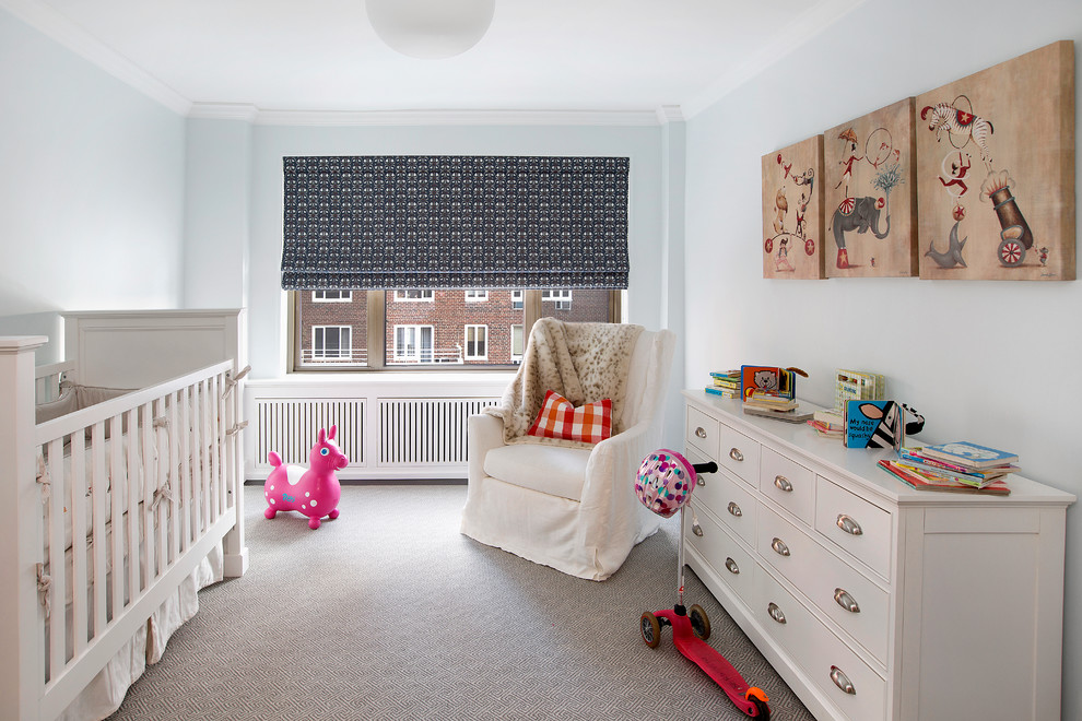This is an example of a mid-sized traditional gender-neutral nursery in New York with blue walls, carpet and grey floor.