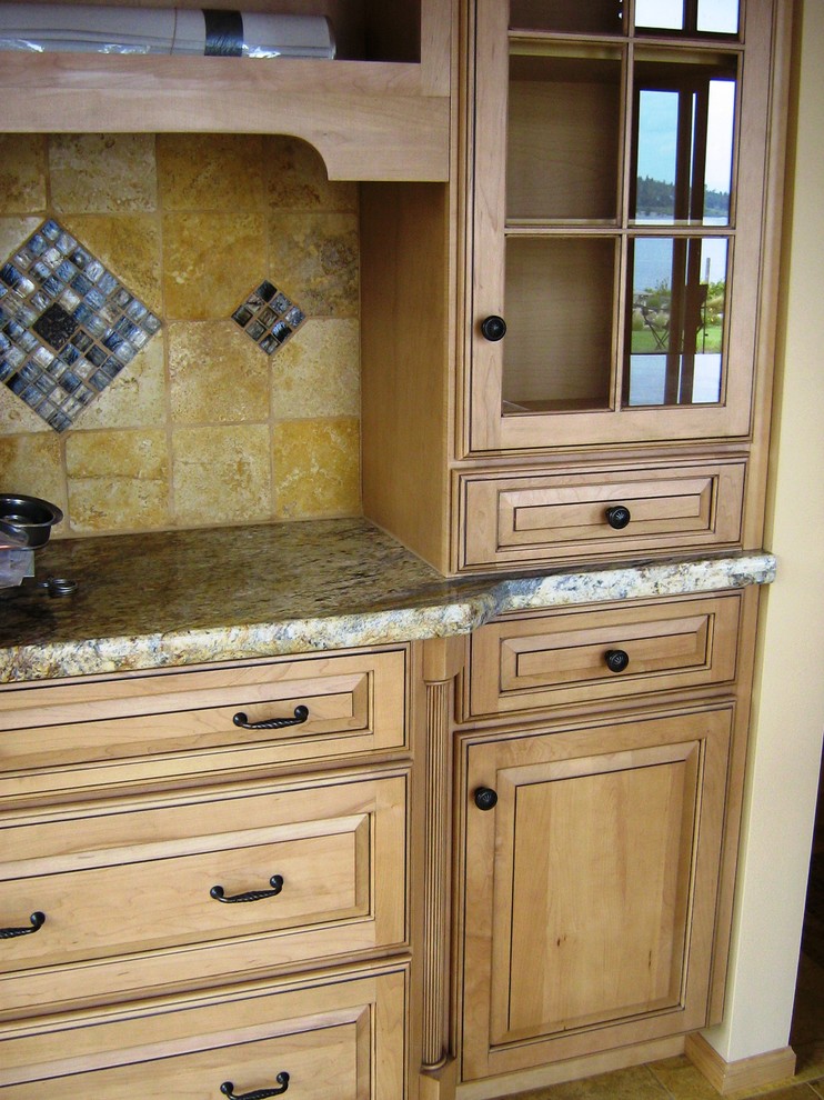 Example of a mountain style kitchen design in Seattle with raised-panel cabinets, granite countertops, yellow backsplash and stone tile backsplash