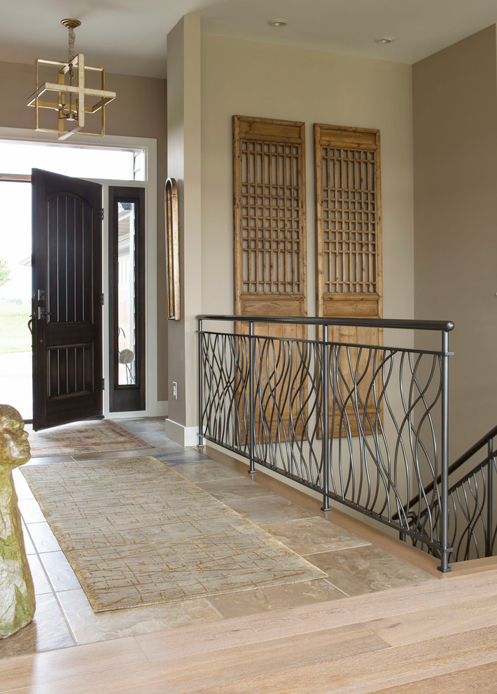 Photo of a transitional foyer in Minneapolis with beige walls, a single front door and a dark wood front door.