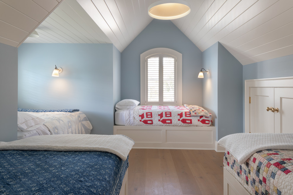 Mid-sized beach style gender-neutral light wood floor, brown floor and shiplap ceiling kids' room photo in New York with blue walls