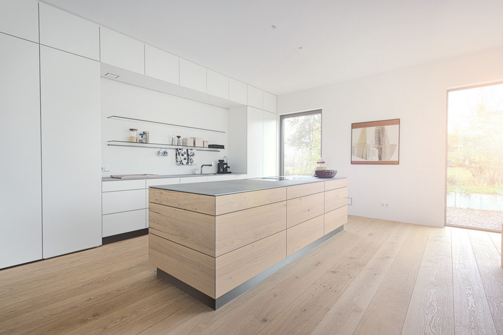 Photo of a large contemporary open plan kitchen in Nuremberg with medium wood cabinets, medium hardwood floors, with island, a single-bowl sink and flat-panel cabinets.