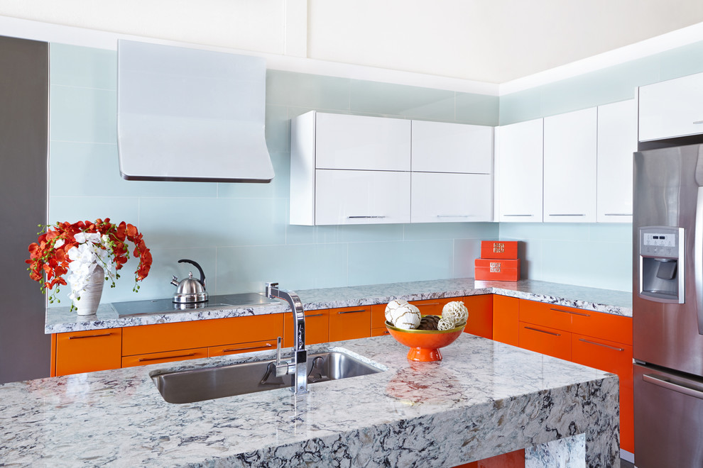 Photo of a mid-sized contemporary l-shaped open plan kitchen in San Francisco with a drop-in sink, flat-panel cabinets, orange cabinets, marble benchtops, blue splashback, stainless steel appliances and with island.