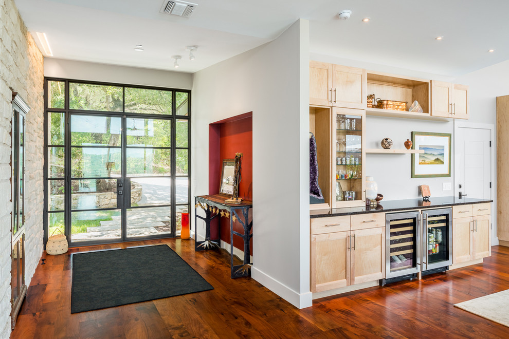 Mid-sized contemporary front door in Austin with medium hardwood floors, a double front door and a glass front door.