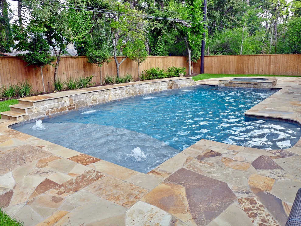 Inspiration for a mid-sized transitional backyard rectangular lap pool in Houston with a hot tub and natural stone pavers.