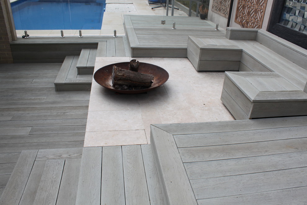 Inspiration for an expansive mediterranean backyard deck in Melbourne with a fire feature.