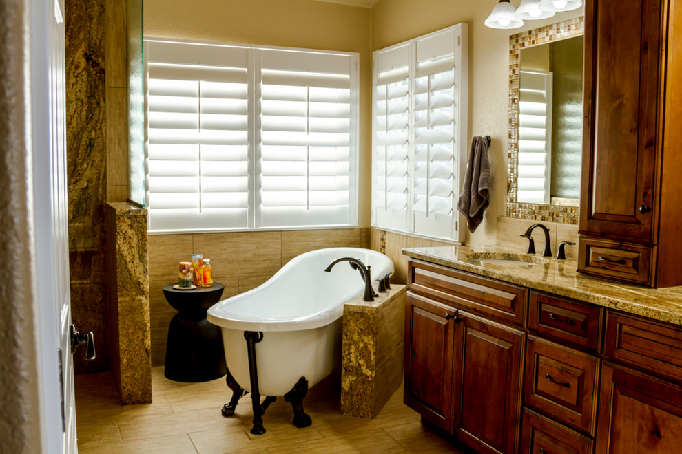 Design ideas for a mid-sized traditional master bathroom in Denver with raised-panel cabinets, dark wood cabinets, a claw-foot tub, an open shower, beige tile, white tile, glass tile, beige walls, ceramic floors, an undermount sink, granite benchtops and beige floor.