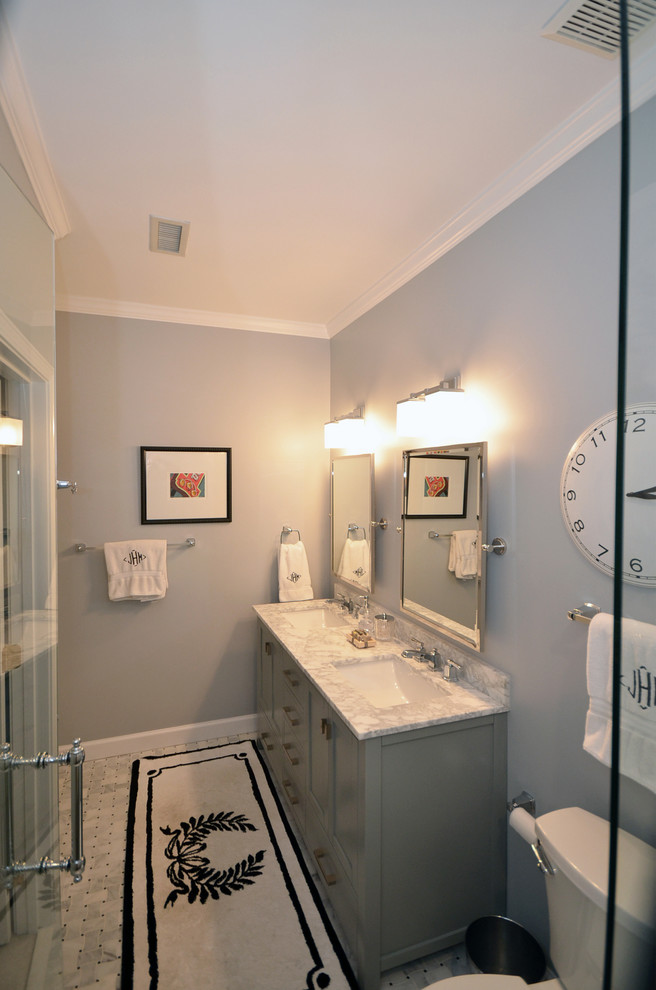 Photo of a mid-sized traditional master bathroom in Charlotte with shaker cabinets, grey cabinets, an alcove shower, a two-piece toilet, gray tile, stone slab, blue walls, marble floors, an undermount sink and marble benchtops.