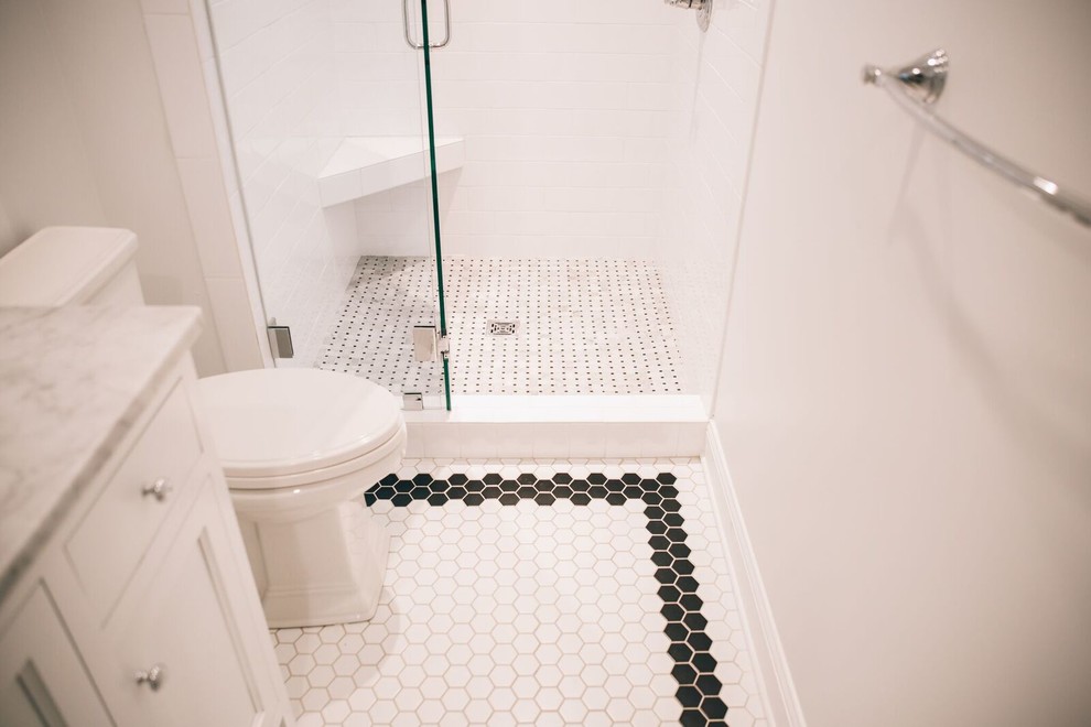 Photo of a mid-sized contemporary 3/4 bathroom in Birmingham with an alcove shower, black and white tile, porcelain tile, porcelain floors, recessed-panel cabinets, white cabinets, a one-piece toilet, white walls, an undermount sink and marble benchtops.