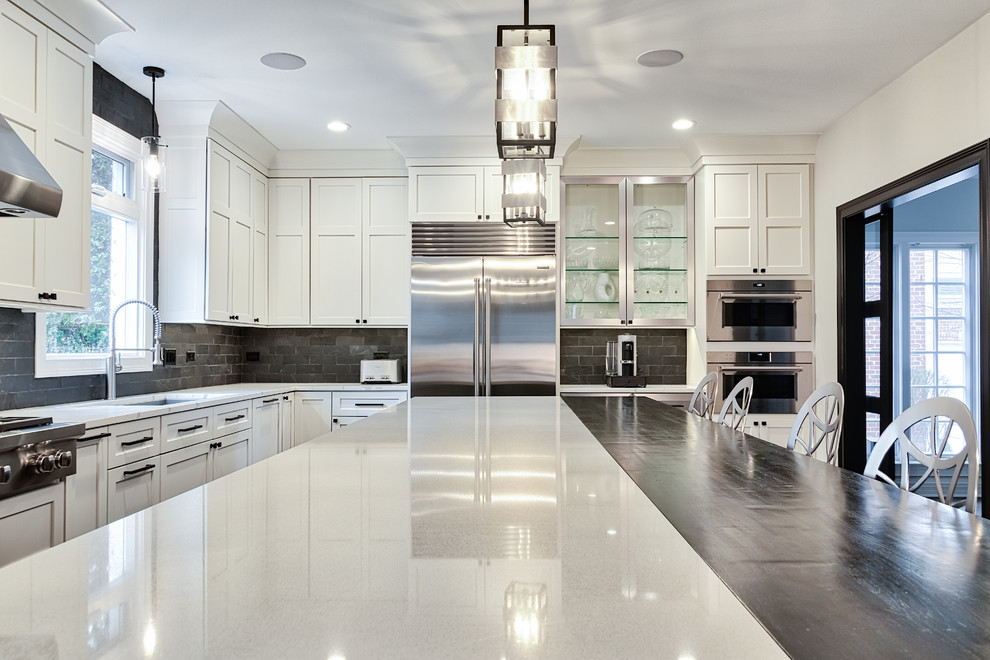 Large transitional u-shaped medium tone wood floor and brown floor kitchen pantry photo in Nashville with an undermount sink, shaker cabinets, dark wood cabinets, solid surface countertops, black backsplash, brick backsplash, stainless steel appliances, an island and white countertops