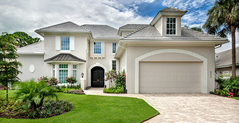 Design ideas for a large transitional two-storey stucco grey exterior in Miami with a hip roof.