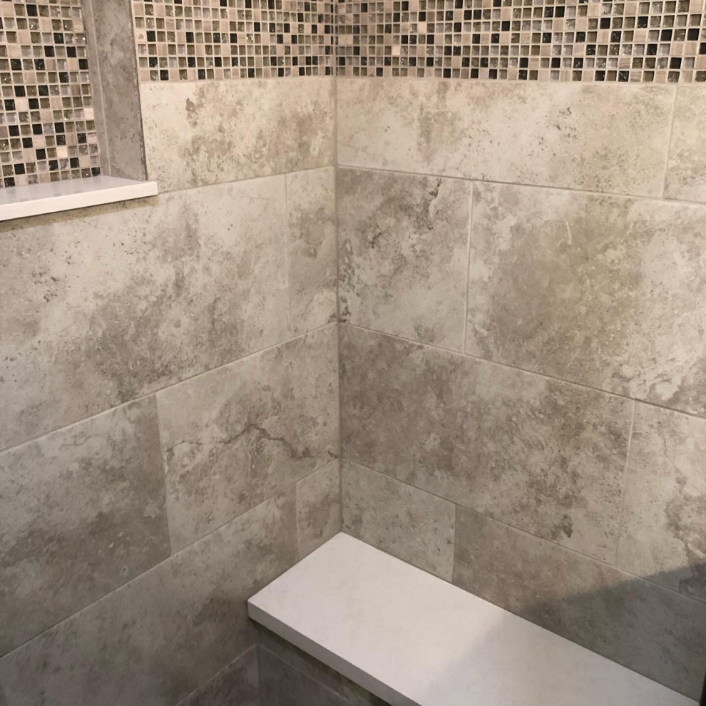 Photo of a large country master bathroom in Los Angeles with shaker cabinets, grey cabinets, a freestanding tub, a one-piece toilet, gray tile, porcelain tile, beige walls, porcelain floors, an undermount sink, engineered quartz benchtops, grey floor, a hinged shower door, white benchtops, an enclosed toilet, a double vanity, a built-in vanity, vaulted and decorative wall panelling.