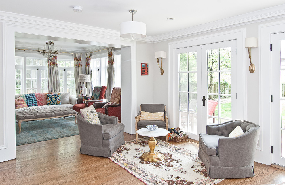 Photo of a traditional living room in Chicago with white walls and medium hardwood floors.